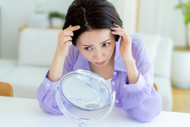 白髪がないか気にする女性